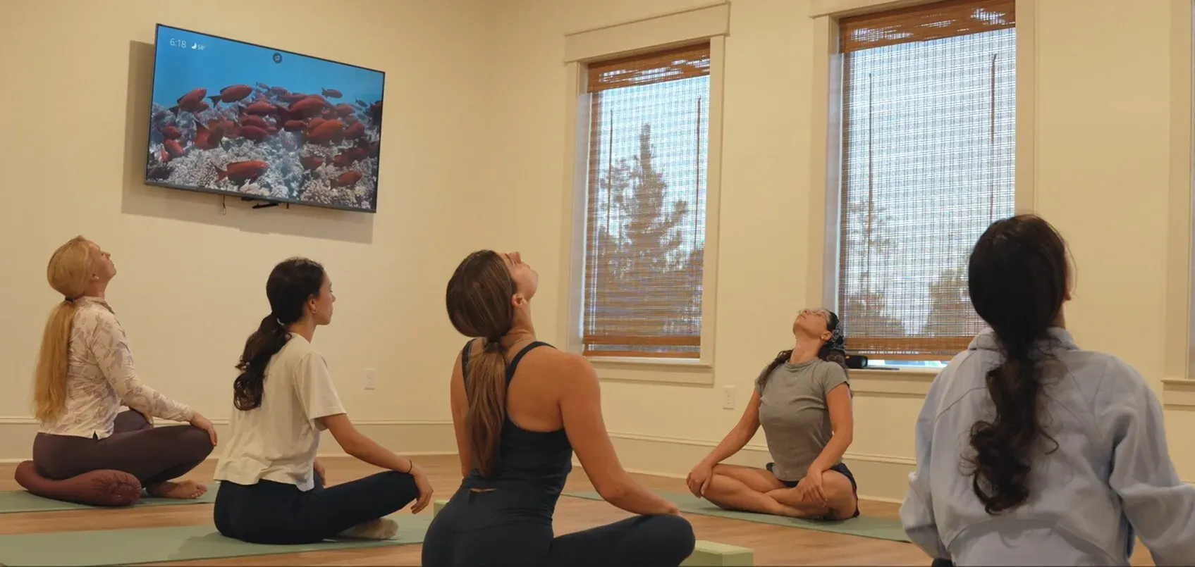 Residents doing yoga in the fitness studio