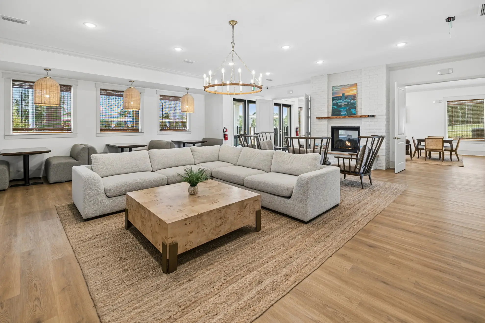 Clubhouse lounge with a sectional sofa, chandelier, and dining area