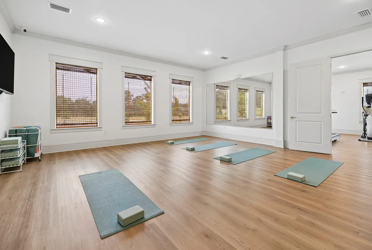 Yoga and stretching room with mats and large windows