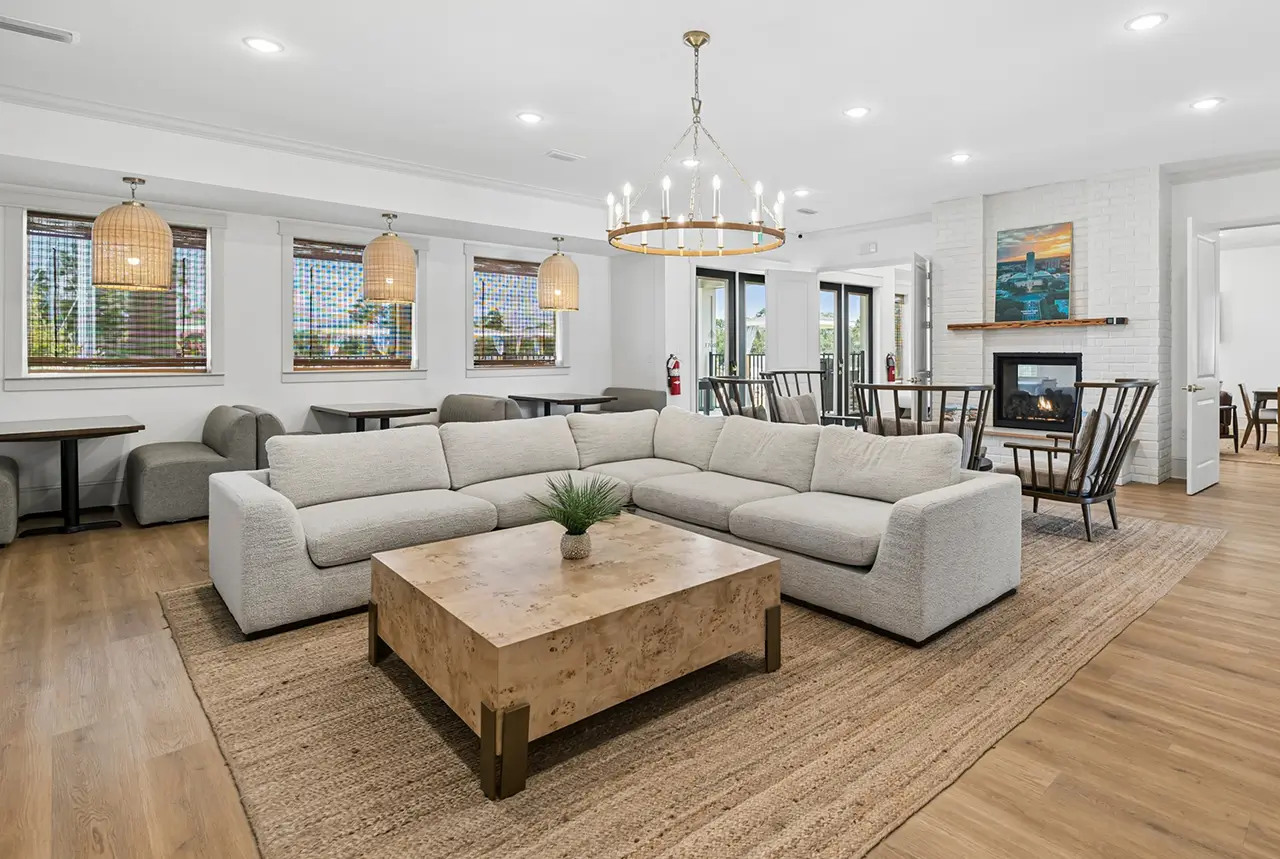 Clubhouse lounge with a sectional sofa, chandelier, and dining area