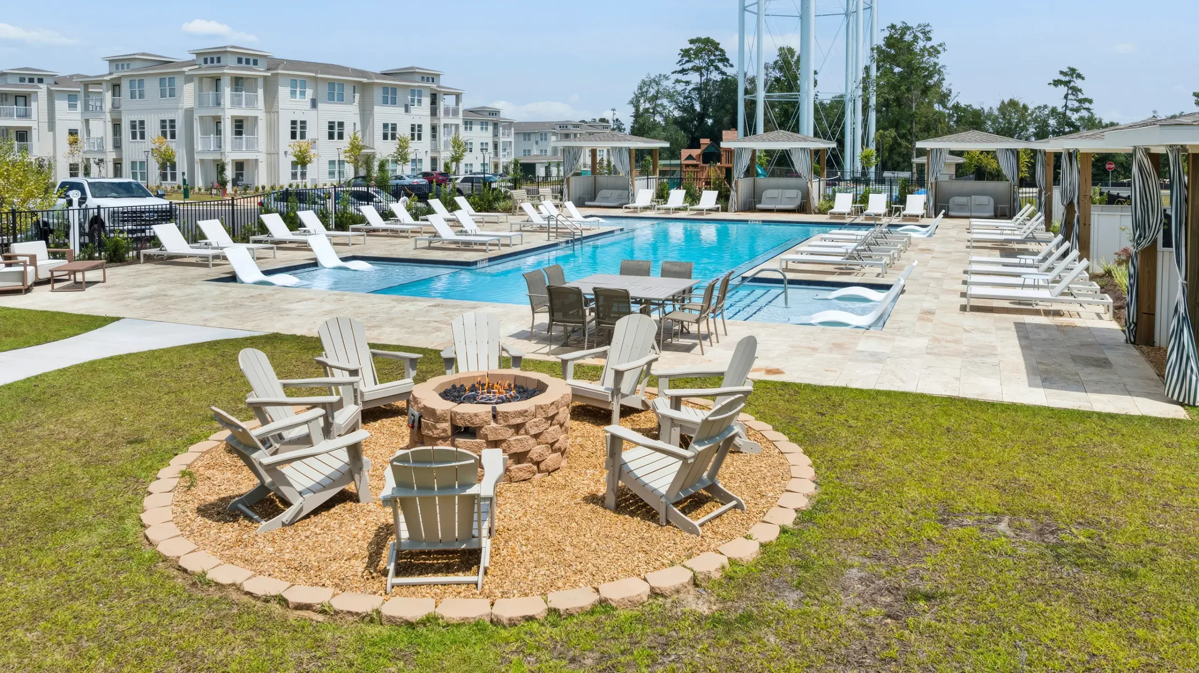Fire pit with Adirondack chairs overlooking the resort-style pool