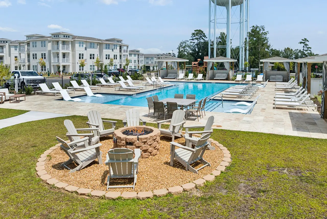 Fire pit with Adirondack chairs overlooking the resort-style pool